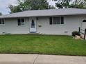 Charming single-story home with a well-maintained lawn and an attractive front door at 1918 Sumac Pl, Longmont, CO 80501
