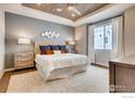 Serene main bedroom features wood-look ceiling, plush bed, soft rug, and bright natural light at 2739 Crystal Springs Ln, Longmont, CO 80503