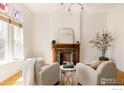 Cozy living room features fireplace, bright window, hardwood floors and modern decor at 2808 N Humboldt St, Denver, CO 80205
