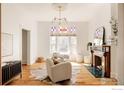 Inviting living room featuring a fireplace, bright window, and stylish decor at 2808 N Humboldt St, Denver, CO 80205