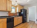 A functional kitchen featuring wood cabinets, black appliances, and tile flooring at 2901 Lorraine Ct, Boulder, CO 80304