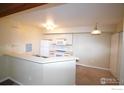 Bright kitchen featuring a bar, white appliances, and neutral countertops overlooking the living room at 30 S Boulder Cir # 3018, Boulder, CO 80303