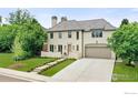 Elegant home with well-manicured lawn, two-car garage, and gray tile roof under a blue sky at 315 Fairfax St, Denver, CO 80220