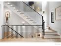 Modern staircase with wood treads, black metal railing, and stylish decorative lighting at 315 Fairfax St, Denver, CO 80220