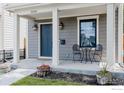 Inviting front porch with stylish decor, featuring a cozy seating area and decorative plants at 3346 N Josephine St, Denver, CO 80205