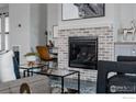 Living room featuring a brick fireplace and contemporary decor at 3346 N Josephine St, Denver, CO 80205
