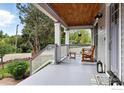 Relaxing covered porch with wood chair, welcome mat, and charming lantern decor at 3561 4Th St, Boulder, CO 80304