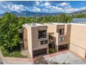 Beautiful exterior view with mountain backdrop and mature trees surrounding property at 3805 Northbrook Dr # A, Boulder, CO 80304