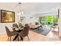 Bright living room with modern dining table and sliding glass doors to the outdoor patio at 3805 Northbrook Dr # A, Boulder, CO 80304
