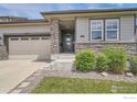 Close up of exterior of home featuring stone accents and covered porch at 4343 E 96Th Way, Thornton, CO 80229