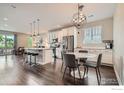 Bright kitchen featuring stainless steel appliances, seating area, and hardwood floors at 4343 E 96Th Way, Thornton, CO 80229