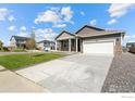 Charming one-story home featuring neutral siding, stone accents, and a well-manicured lawn at 4692 Hatcher Dr, Brighton, CO 80601