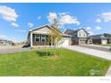 Charming one-story home featuring neutral siding, stone accents, and a well-manicured lawn at 4692 Hatcher Dr, Brighton, CO 80601