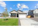 Charming one-story home featuring neutral siding, stone accents, and a well-manicured lawn at 4692 Hatcher Dr, Brighton, CO 80601