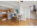 Cozy dining area with hardwood floors and an adjacent open kitchen area with ample sunlight at 4725 Spyglass Dr, Broomfield, CO 80023