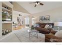 Spacious living room with vaulted ceilings, a ceiling fan, and plush seating for entertaining at 4725 Spyglass Dr, Broomfield, CO 80023