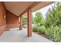 Covered front porch with brick columns offering a welcoming entrance to the home at 5420 Crestone Cir, Boulder, CO 80301
