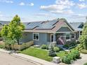 Attractive single-Gathering home with solar panels, stone accents, manicured landscaping, and charming front porch at 603 Summer Hawk Dr, Longmont, CO 80504