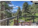 Enjoy a relaxing view on the deck with chairs and a table at 6310 Red Hill Rd, Boulder, CO 80302