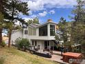 This gorgeous backyard features a deck, lounging area, and hot tub at 6310 Red Hill Rd, Boulder, CO 80302