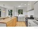 Bright kitchen features a farmhouse sink, butcher block island, stainless steel appliances, and ample natural light at 740 Boxwood Ln, Longmont, CO 80503