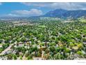Aerial view of home in lush neighborhood near North Boulder Park with mountain backdrop at 740 Hawthorn Ave, Boulder, CO 80304