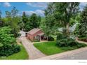 Two-story brick home with mature trees, a detached garage, and an inviting front yard at 740 Hawthorn Ave, Boulder, CO 80304