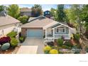 Charming one-story home with a brick facade and a well-manicured front yard at 742 Megan Ct, Longmont, CO 80504