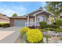 Charming one-story home featuring a well-kept lawn, and a two car garage at 742 Megan Ct, Longmont, CO 80504