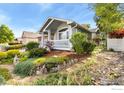 Charming one-story home with a large porch and a beautifully landscaped front yard at 742 Megan Ct, Longmont, CO 80504