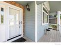 Inviting front porch with a cozy seating area, perfect for relaxing and enjoying the outdoors at 742 Megan Ct, Longmont, CO 80504
