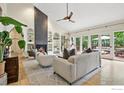 Cozy living room with a modern fireplace, built-in shelving, and large windows offering natural light at 7760 Crestview Ln, Niwot, CO 80504