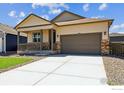 Charming single-Gathering home with a covered front porch and an attached two-car garage at 845 Leeward St, Lochbuie, CO 80603