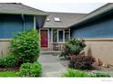 A charming front entrance, featuring a red door, skylights, and well-maintained landscaping at 901 Welch Ave, Berthoud, CO 80513