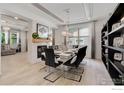Elegant dining room with modern lighting, fireplace, and decorative shelving at 9527 Loveland Way, Arvada, CO 80007
