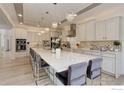 Spacious kitchen with pendant lighting, modern appliances, and large island with seating at 9527 Loveland Way, Arvada, CO 80007