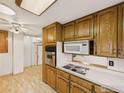 Efficient kitchen with oak cabinetry, updated appliances, and a practical layout for cooking and dining at 10951 Rosalie Dr, Northglenn, CO 80233
