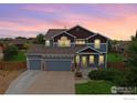 Charming two-story home with a three-car garage, well-manicured lawn, and attractive curb appeal at twilight at 13598 Horseshoe Cir, Mead, CO 80542