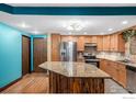 Charming kitchen featuring stainless steel appliances, tile backsplash, and granite countertops at 14000 E Linvale Pl # 210, Aurora, CO 80014