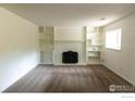 Spacious living room with white brick fireplace and built-in bookshelves at 15532 E Pacific Pl, Aurora, CO 80013