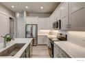 New kitchen featuring white cabinets, stainless steel appliances, and quartz countertops at 218 High Point Dr, Longmont, CO 80504