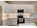 New kitchen featuring white cabinets, stainless steel appliances, and quartz countertops at 218 High Point Dr, Longmont, CO 80504