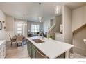 New kitchen featuring gray cabinets, stainless steel appliances, and quartz countertops at 218 High Point Dr, Longmont, CO 80504