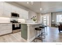 New kitchen featuring gray cabinets, stainless steel appliances, and quartz countertops at 218 High Point Dr, Longmont, CO 80504