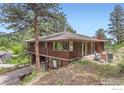 Exterior elevation showing a spacious home, large windows, and an outdoor patio at 27 Arrowleaf Ct, Boulder, CO 80304