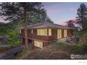 Exterior elevation showing a spacious home, large windows, and an outdoor patio at 27 Arrowleaf Ct, Boulder, CO 80304