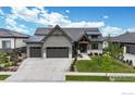 Beautiful home featuring a three-car garage and a well-manicured lawn at 2790 Heron Lakes Pkwy, Berthoud, CO 80513