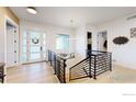Bright foyer with modern staircase and stylish front door with sidelights at 2790 Heron Lakes Pkwy, Berthoud, CO 80513