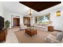 Bright living room with a large window, hardwood floors, and neutral decor at 2800 Lake Hollow Rd, Berthoud, CO 80513
