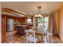 Bright kitchen boasts stainless steel appliances, kitchen island, and adjacent dining area with sliding glass doors at 3722 Monterey Pl, Boulder, CO 80301